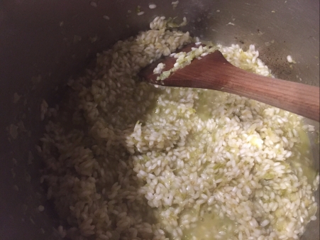 gradually add stock to rice, stirring frequently