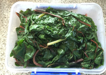 toss greens in a large pan until wilted