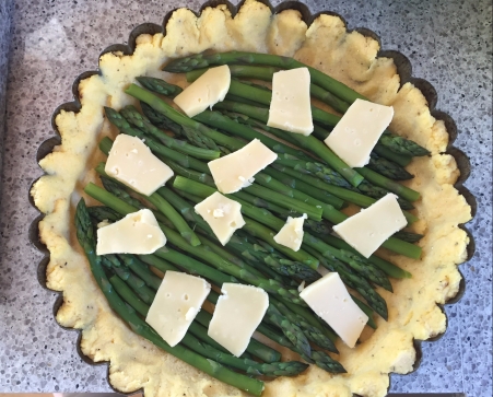 lay asparagus in crust, and top with cheese