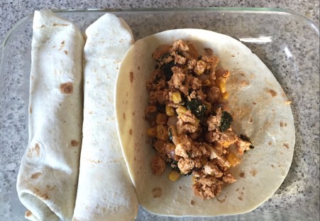 scoop tofu filling into tortillas and roll up